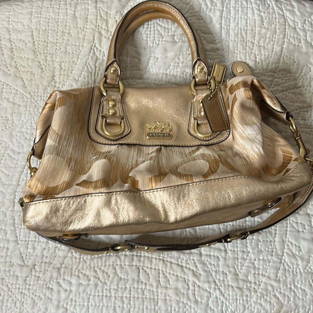 2000s Gold Coach, handles and shoulder strap. Gold with Pink lining.